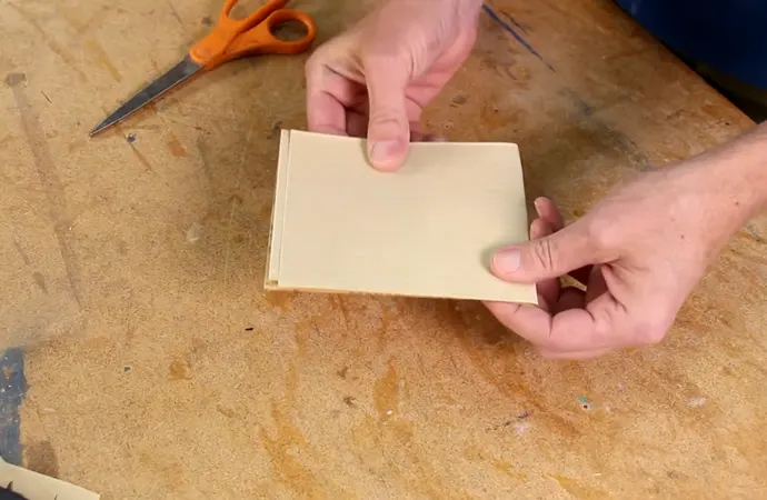 Start using coarse sandpaper such as 80 or 100-grit